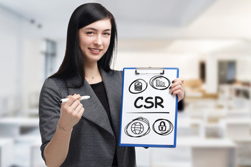 Business, technology, internet and networking concept. Young entrepreneur showing keyword: CSR