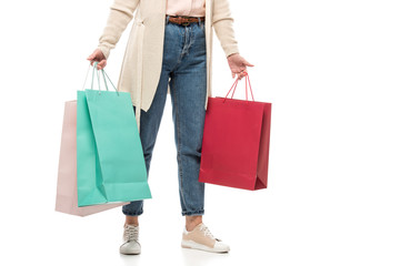 Cropped view of middle aged woman with shopping bags on White
