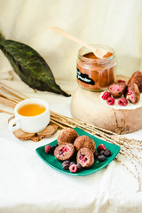 Homemade Healthy Paleo Raw Chocolate Truffles with fresh berries Nuts, Dates and Marzipan.