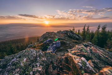 Sunrise on a rocky ridge. Sleeping outside. Sleeping bag on a rocky camping site. Sunrise or sunset in the mountains.
