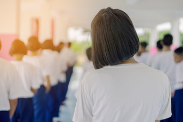 Group of students try to meditate for the peace of mind by walk with Buddhist monk in school.