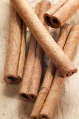 cinnamon sticks on wooden background
