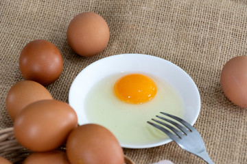 Fresh farm eggs with yolk on bowl 
