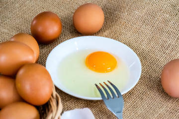 Fresh farm eggs with yolk on bowl 