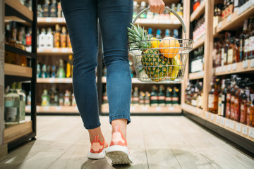 Female customer choosing products in supermarket