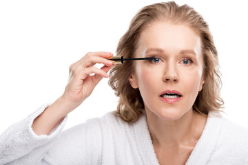 beautiful mature woman applying mascara Isolated On White