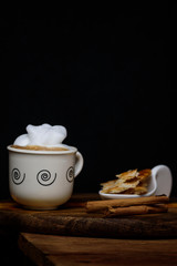 Still life. Cup of coffee on an old wood.