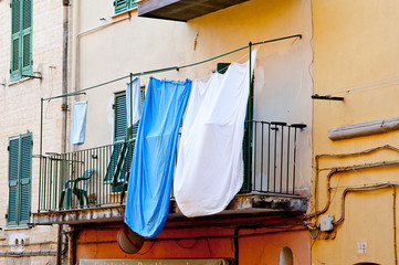 Fototapeta na wymiar Clothes drying on a balcony, Italy