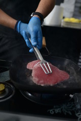 Making dinner at restaurant. Proffesional cooker