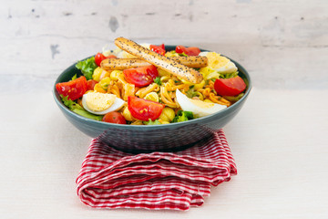 Salad made with cooked pasta, mixed green salads, cherry tomatoes, Mozzarella cheese and smoked ham served with accompaniment