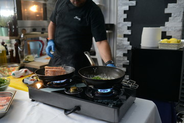 Making dinner at restaurant. Proffesional cooker