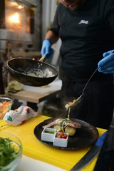 Making dinner at restaurant. Proffesional cooker