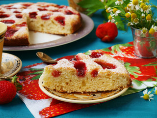 Homemade pie with strawberries, located on a plate on a blue background