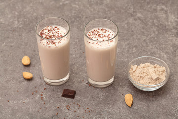 Healthy chocolate banana protein shake with almond milk in a glass. 