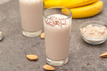 Healthy chocolate banana protein shake with almond milk in a glass. 