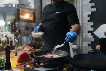 Making dinner at restaurant. Proffesional cooker