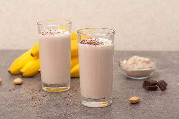 Healthy chocolate banana protein shake with almond milk in a glass. 