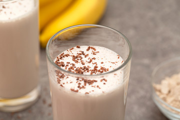 Healthy chocolate banana protein shake with almond milk in a glass. 