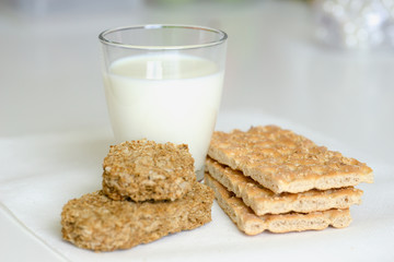 Fototapeta na wymiar The concept of health, diet, proper nutrition. Healthy wheat crackers, crispbreads, grain crackers,milk.