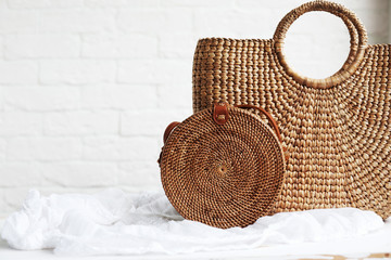 Beautiful and stylish rattan bags on a wooden table. concept