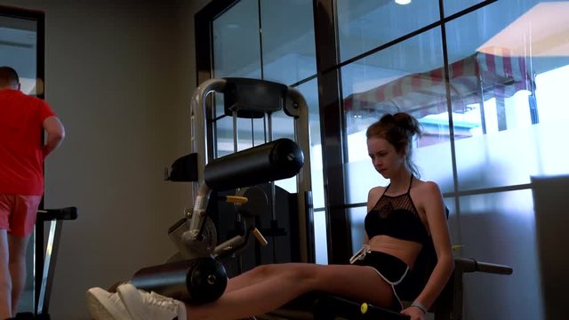 Young girl using abdominal crunch machine in a gym