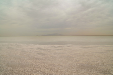Sunrise. Salt Lake Karum (also known as Lake Assale or Asale) it lies at −120 m (−394 ft) relative to sea level. Ethiopia, Afar Region, Danakil Depression (Afar Triangle or Afar Depression)