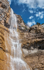 Beautiful waterfall with cloudy sky landscape. Uchan su waterfall in Yalta, Crimea, Russia.