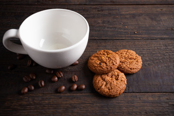 cookies and White coffee cup on wooden table.