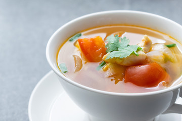 Hot soup chicken healthy at morning on concrete table.