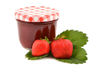 Glass jar of strawberry jam and fresh berries, isolated on white background. Preserved fruits.