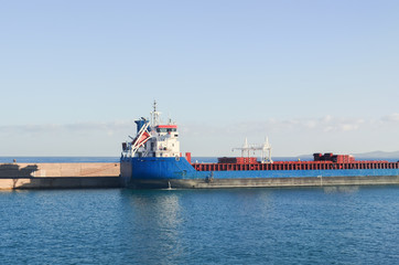 The barge standing in the sea dock in the early morning. Creete, Greece