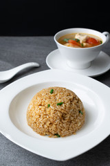 Garlic fried rice and hot soup chicken healthy at morning on concrete table.