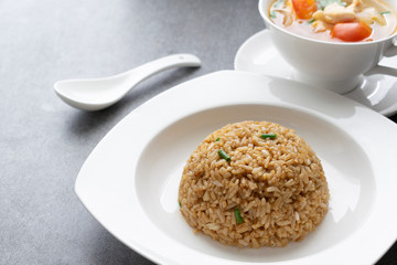 Garlic fried rice and hot soup chicken healthy at morning on concrete table.