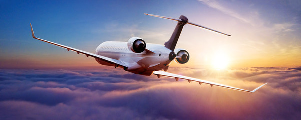 Private jet plane flying in sunset