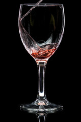 Wine glass with red wine or empty on black background