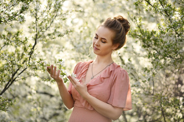 young woman in the park with flowers