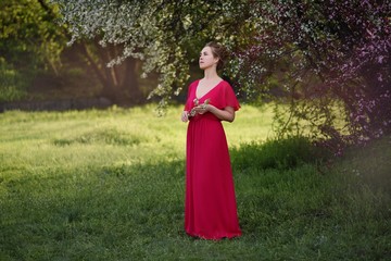 young woman with a bouquet of flowers. portrait of a young woman in a park