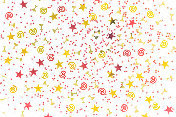 Golden stars and flutes and swirls glitter and assorted sparkling confetti partially blurred isolated on white background. Festive holiday pastel backdrop