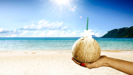 Woman hand and fresh coconut drink 