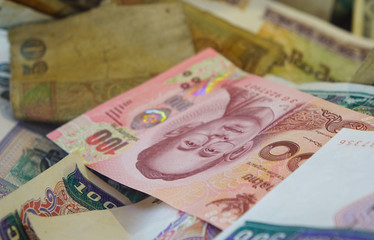 Pile of Burmese money in donation box