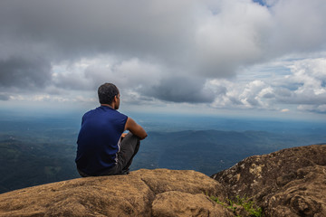 Man Isolated watching landscape from hilltop