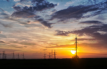 Fototapeta na wymiar electric wires and towers at sunset.