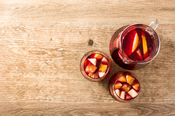 Red wine sangria in glass on wooden table. Top view