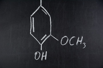 Chemical structure formula written on black chalkboard