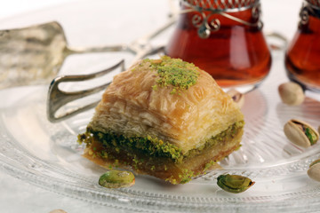Middle eastern or arabic dishes. Turkish Dessert Baklava with pistachio on dishes