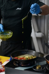 Making dinner at restaurant. Proffesional cooker