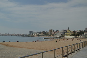 Naklejka premium April 15, 2014. Estoril, Cascais, Sintra, Lisbon, Portugal. Bathers On The Beach Of Poca On The Coast Of Estoril. Travel, Nature, Landscape.