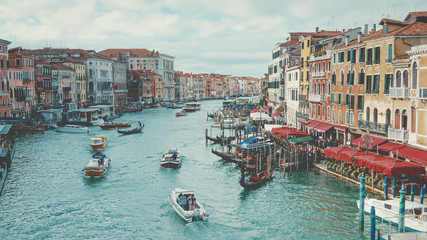 Venice, Italy boats and city skyline on the Grand Canal, faces and logos blurred for commercial use