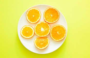 Fresh oranges cut in slice on green background. Healthy food. Fresh vitamins. Vegetarian.
