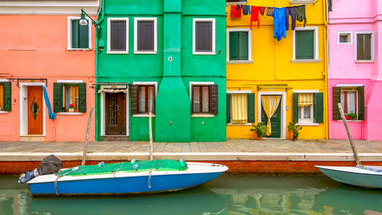 Fototapeta na wymiar Laundry hanging to dry from clothesline in colorful neighborhood on Burano Island, Venice, Italy
